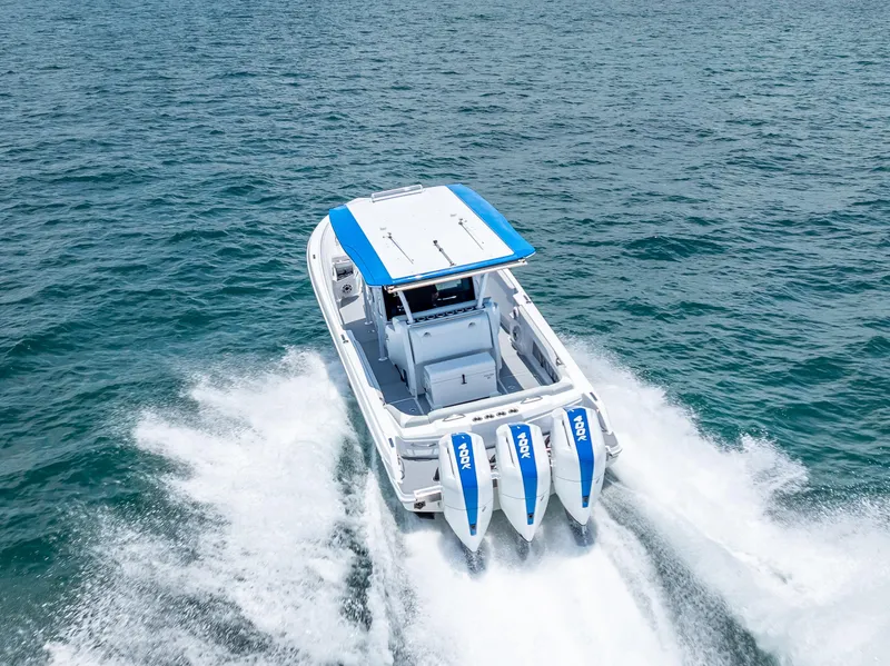 Slide: The Image of 2025 Nor-Tech 340 Sport boat cruising on open water with triple engines. - 49