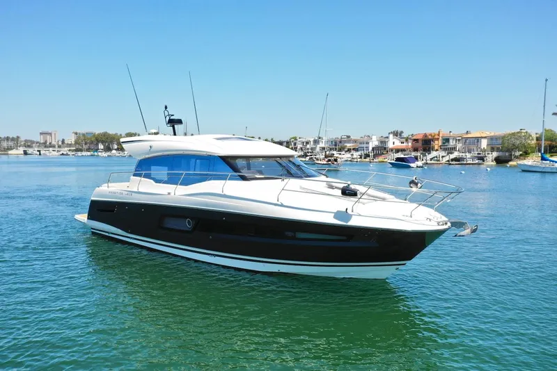 Slide: The Image of 2020 Prestige 460S yacht on calm water, with a clear blue sky background. - 0