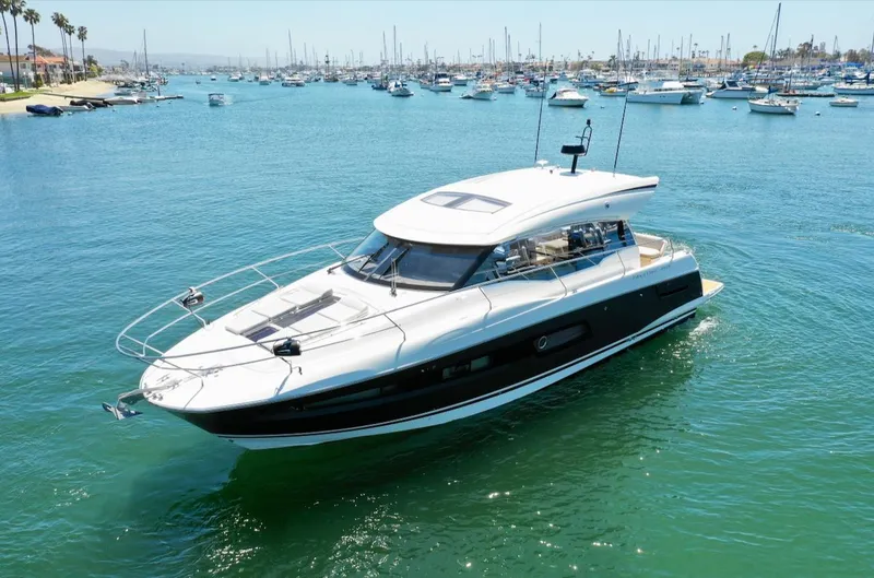 Slide: The Image of 2020 Prestige 460S yacht cruising in a marina with numerous boats in the background. - 1