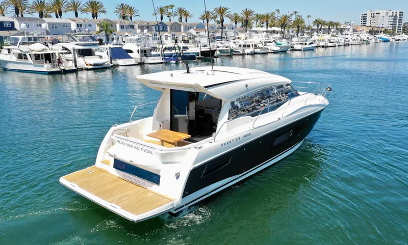 Slide: The Image of 2020 Prestige 460S yacht cruising in a marina with palm trees and boats. - 12