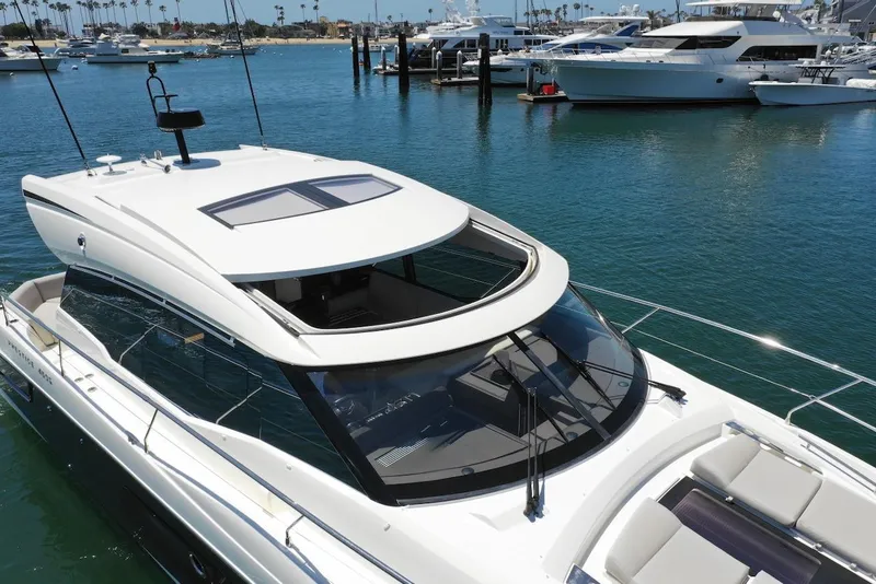 Slide: The Image of 2020 Prestige 460S yacht docked in marina, surrounded by water and other boats. - 14