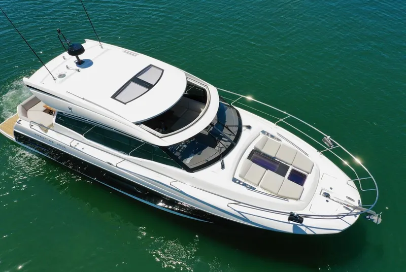 Slide: The Image of 2020 Prestige 460S yacht cruising on clear blue water, aerial view. - 15