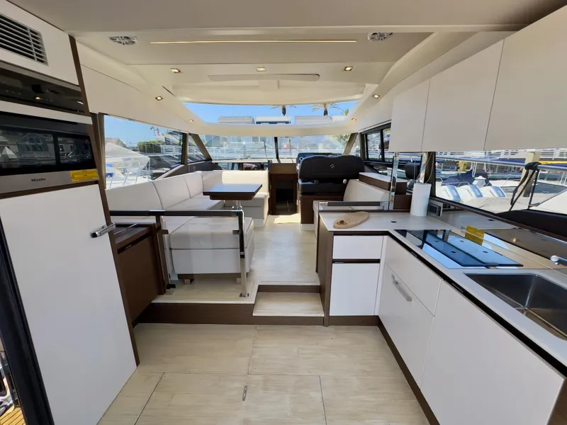 Slide: The Image of Luxurious interior of 2020 Prestige 460S yacht with modern kitchen and seating area. - 17