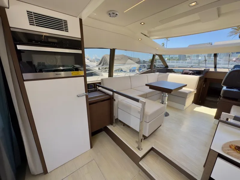 Slide: The Image of Luxurious interior of 2020 Prestige 460S yacht with modern seating and dining area. - 18
