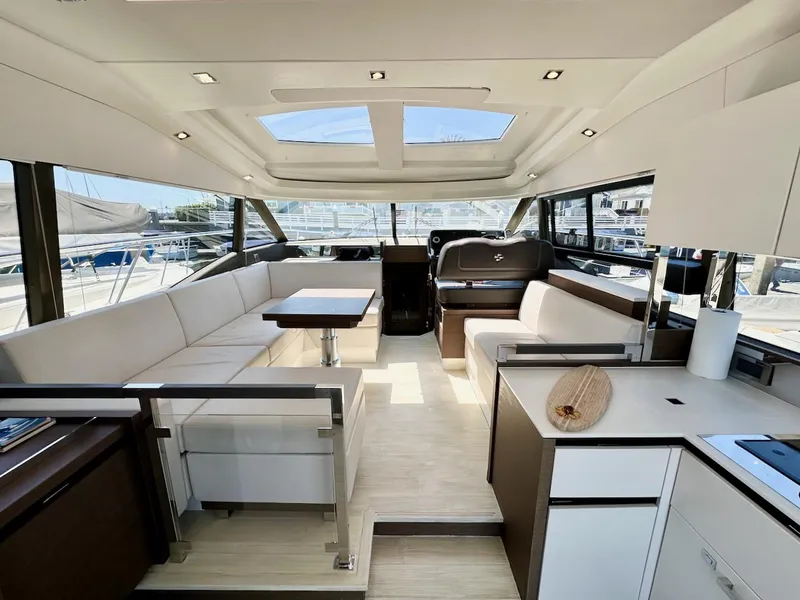 Slide: The Image of Luxurious interior of a 2020 Prestige 460S yacht with modern furnishings and ample natural light. - 20