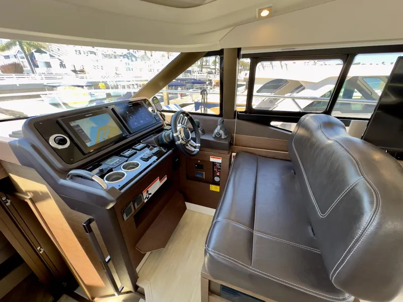 Slide: The Image of Interior helm of 2020 Prestige 460S yacht with leather seating and navigation controls. - 24