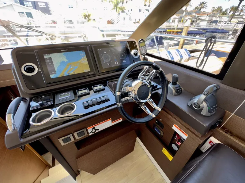 Slide: The Image of Prestige 460S 2020 yacht helm with navigation screens and controls. - 25
