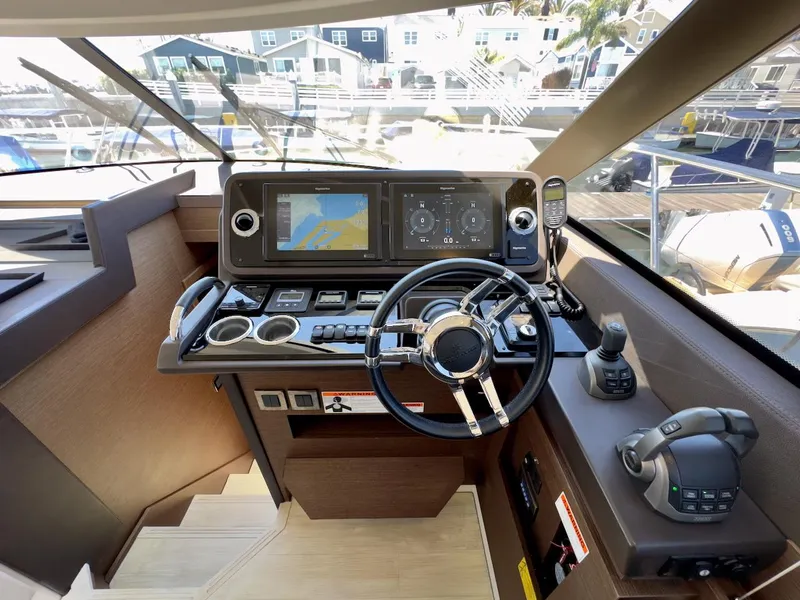 Slide: The Image of Cockpit of 2020 Prestige 460S yacht with modern navigation controls and steering wheel. - 26