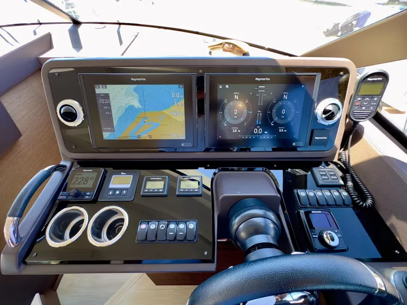 Slide: The Image of Control panel of a 2020 Prestige 460S yacht with navigation screens and instruments. - 27