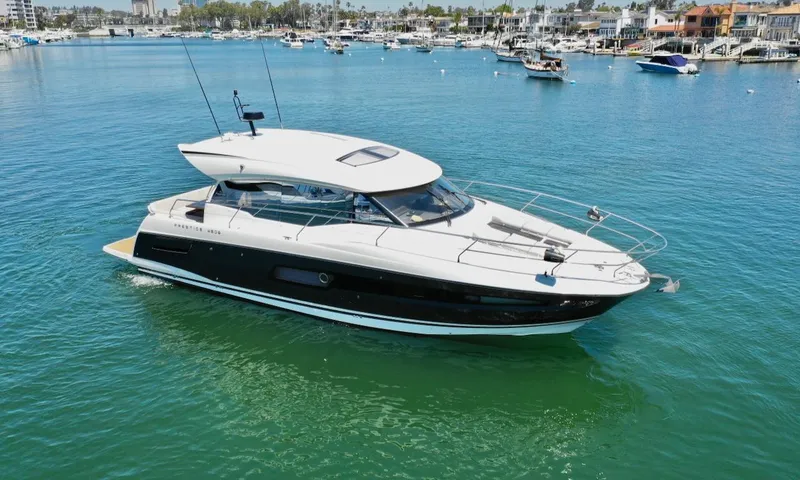 Slide: The Image of 2020 Prestige 460S yacht cruising in a marina with clear blue water. - 3