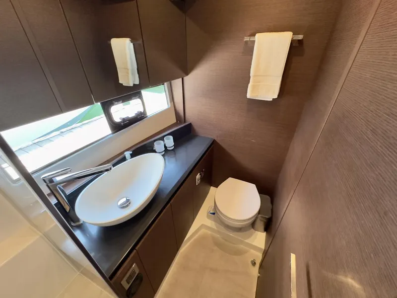 Slide: The Image of Luxurious bathroom in 2020 Prestige 460S yacht with modern sink and toilet. - 30