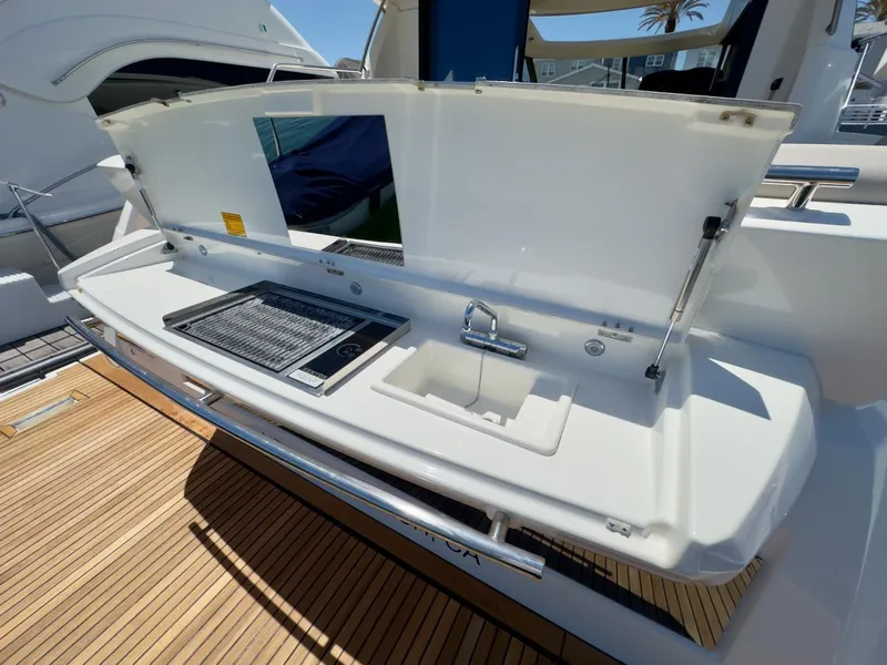 Slide: The Image of 2020 Prestige 460S yacht outdoor kitchen with grill and sink on teak deck. - 36