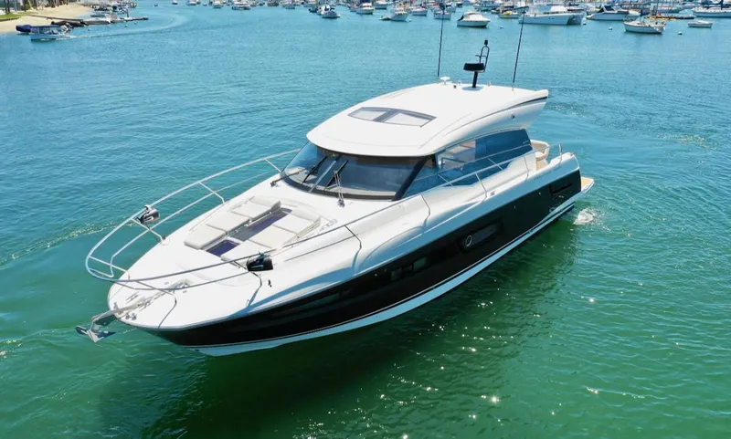 Slide: The Image of 2020 Prestige 460S yacht cruising in a vibrant blue marina. - 7