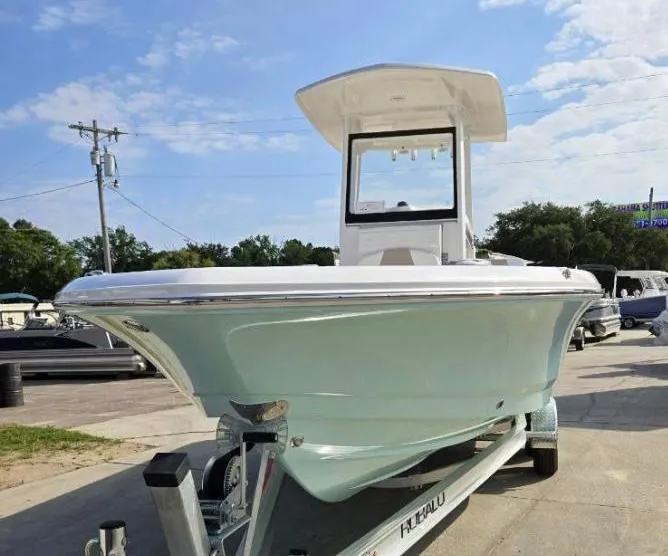Slide: The Image of 2024 Robalo 246 Cayman boat on trailer, displayed outdoors under a clear sky. - 1