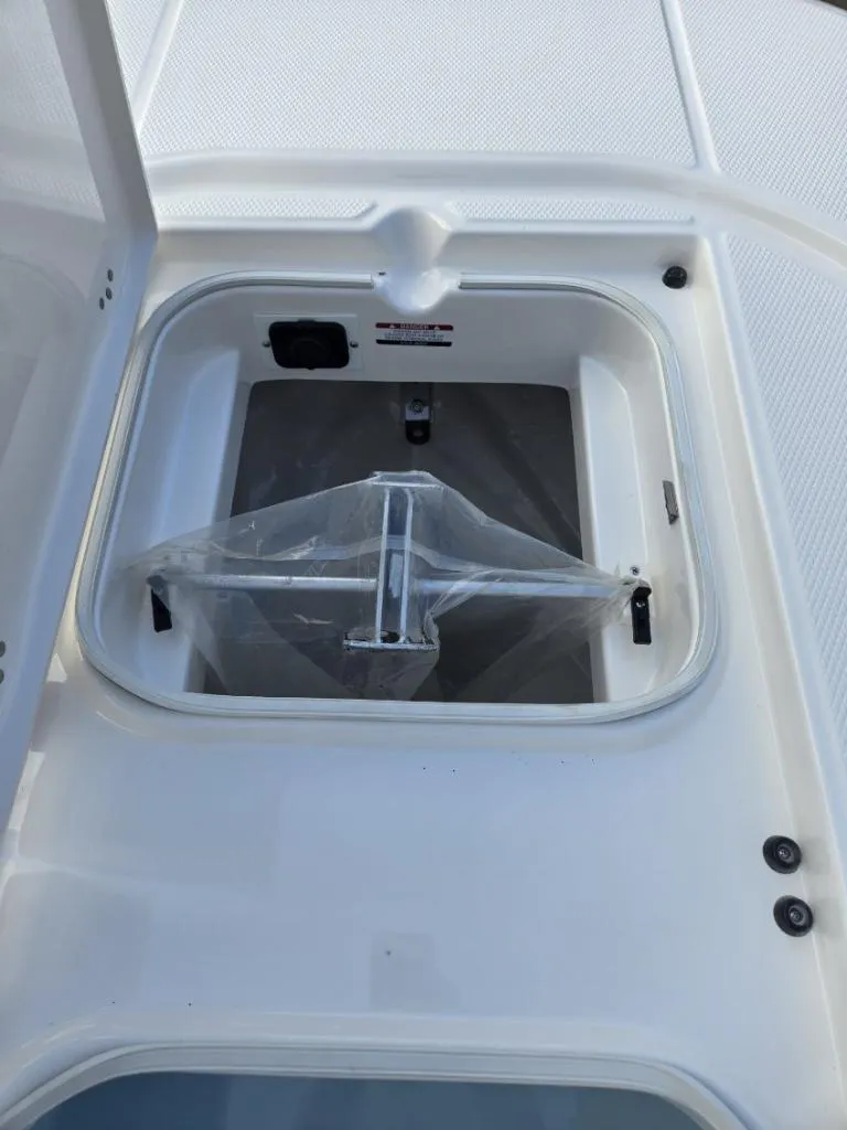 Slide: The Image of 2024 Robalo 246 Cayman boat anchor storage compartment, open hatch view. - 15