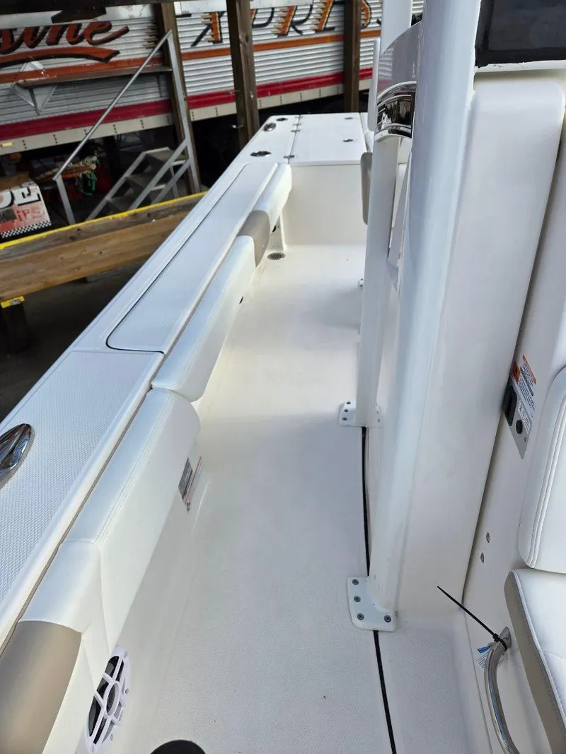 Slide: The Image of 2024 Robalo 246 Cayman boat deck, featuring sleek white design and modern fittings. - 16