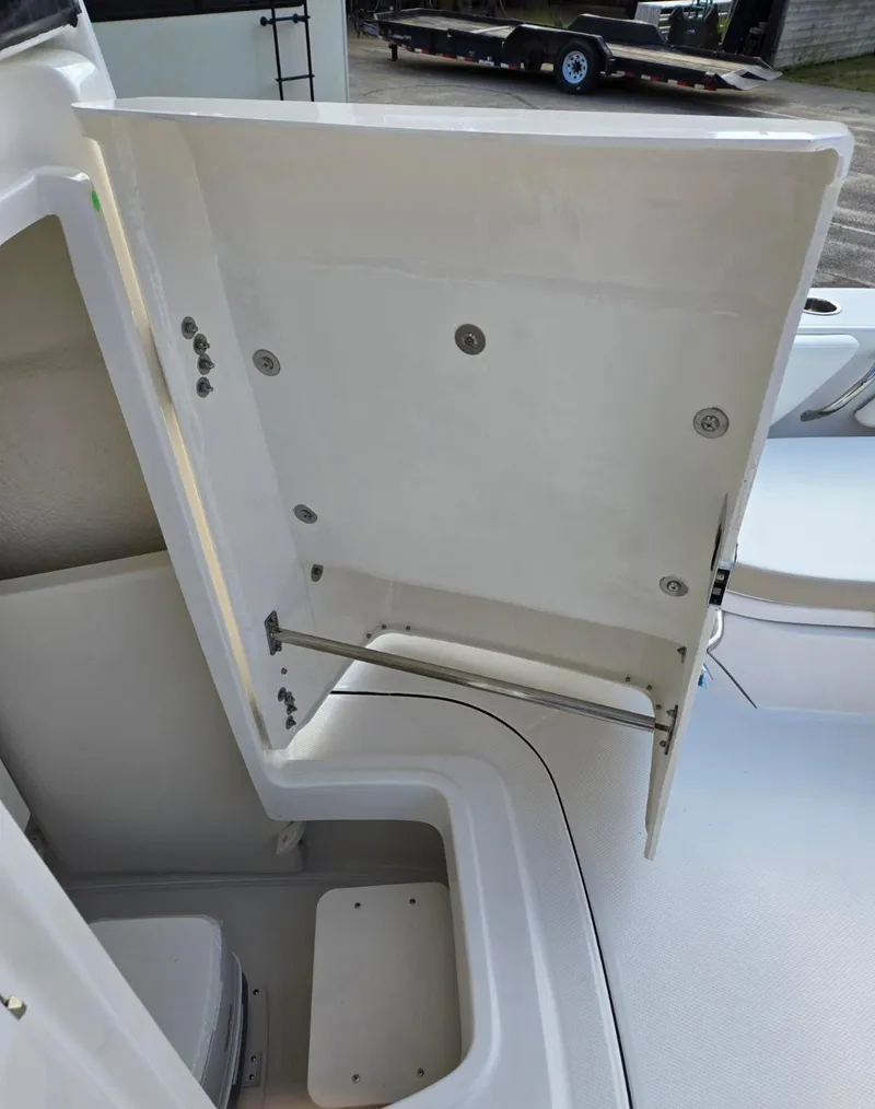 Slide: The Image of 2024 Robalo 246 Cayman boat storage compartment with open hatch, showcasing interior space. - 18