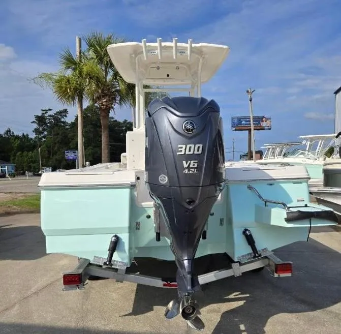 Slide: The Image of 2024 Robalo 246 Cayman boat with Yamaha 300 V6 engine, parked outdoors. - 6