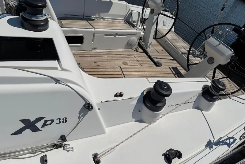 Slide: The Image of 2016 X-Yachts Xp38 sailboat deck with winches and dual steering wheels. - 13