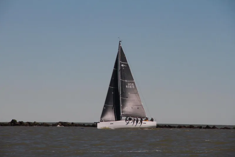Slide: The Image of 2016 X-Yachts Xp38 sailing on open water under clear skies. - 3