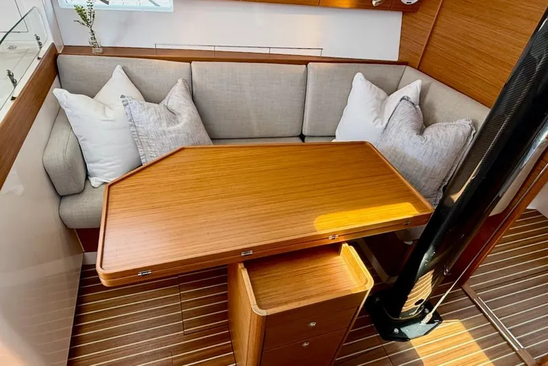 Slide: The Image of Luxurious interior of 2016 X-Yachts Xp38 with wooden table and cushioned seating. - 32