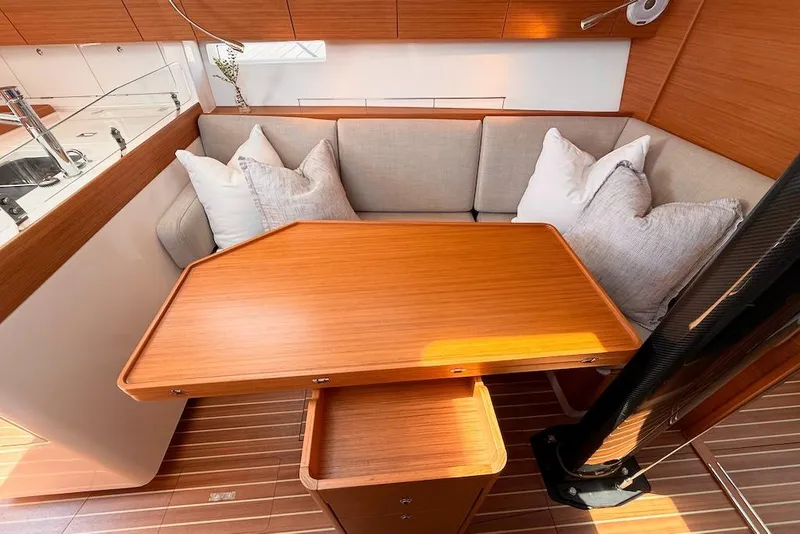 Slide: The Image of Luxurious interior of 2016 X-Yachts Xp38 with wooden table and cushioned seating. - 33