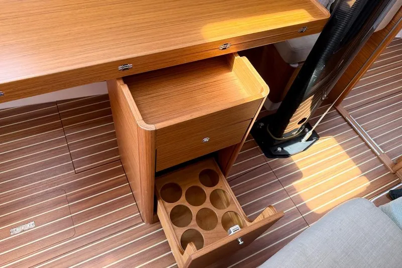 Slide: The Image of Interior of 2016 X-Yachts Xp38 showing wooden cabinetry and flooring with open storage. - 34