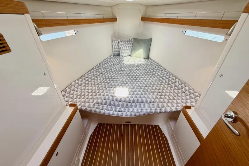 Slide: The Image of Cozy cabin interior of 2016 X-Yachts Xp38 with patterned bedding and wooden accents. - 38