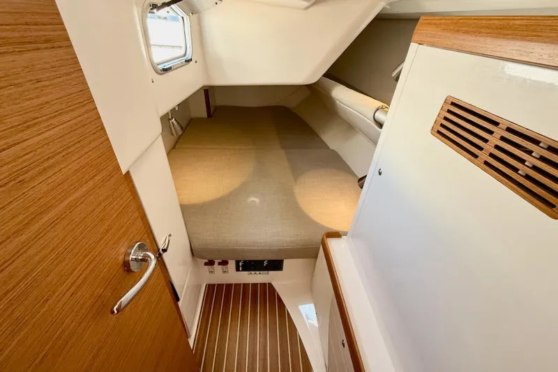 Slide: The Image of 2016 X-Yachts Xp38 cabin interior with wooden accents and cozy sleeping area. - 39