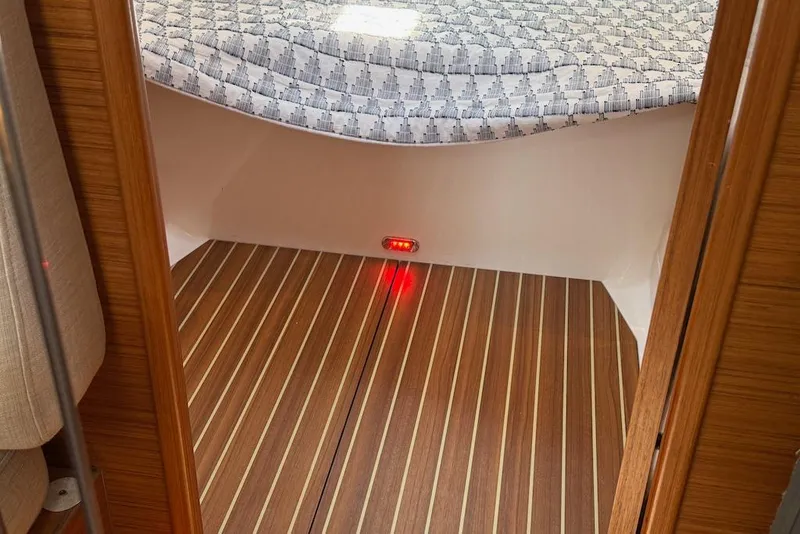 Slide: The Image of Interior of 2016 X-Yachts Xp38 with wooden flooring and patterned bedding. - 41