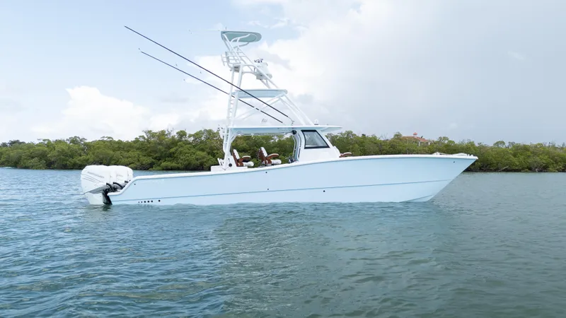 The Image of 2022 Freeman 43 boat on calm water with fishing rods and clear sky. - 0