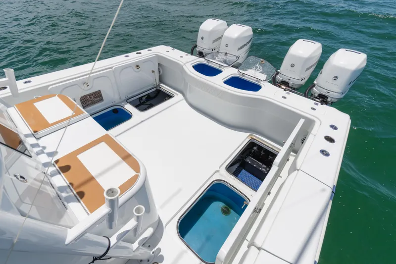 Slide: The Image of 2022 Freeman 43 boat deck with four outboard motors on the ocean. - 11