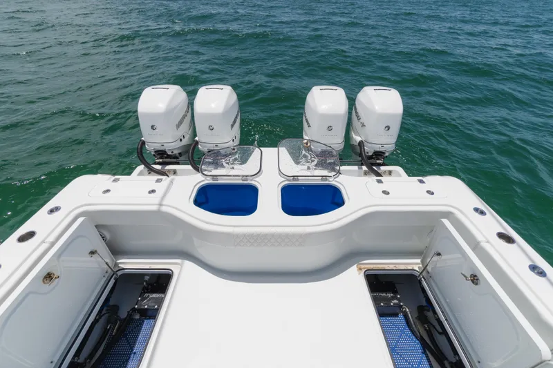 Slide: The Image of 2022 Freeman 43 boat with four outboard motors on open water. - 12