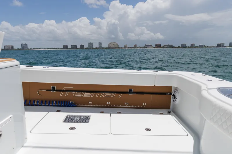 Slide: The Image of Freeman 43 boat deck with ocean view, 2022 model, city skyline in background. - 13
