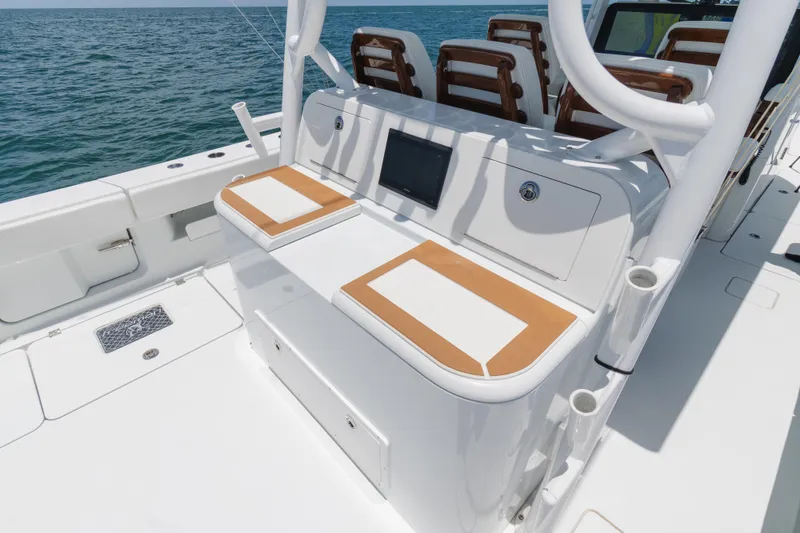 Slide: The Image of 2022 Freeman 43 boat interior with cushioned seating and ocean view. - 15