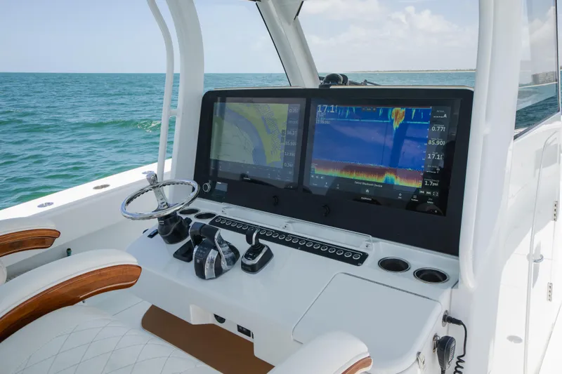 Slide: The Image of Freeman 43 boat dashboard with dual screens and steering wheel, 2022 model. - 19