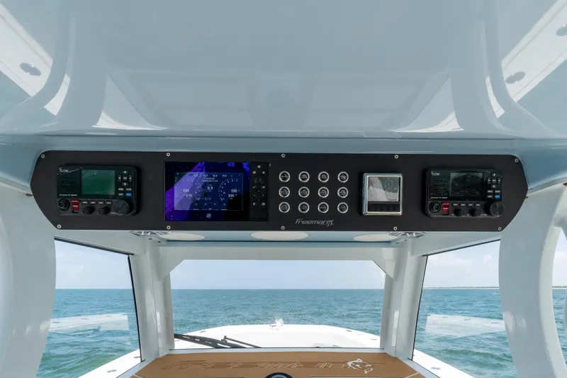 Slide: The Image of Control panel of a 2022 Freeman 43 boat with ocean view in background. - 20
