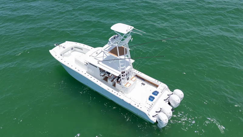 Slide: The Image of 2022 Freeman 43 boat on open water, aerial view, white hull, dual outboard engines. - 3