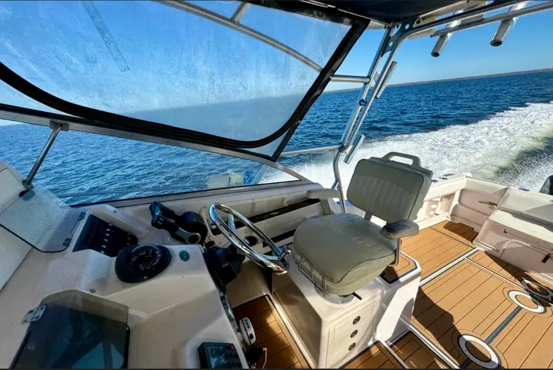 Slide: The Image of 2003 Grady-White Marlin 300 boat interior with ocean view and helm station. - 12
