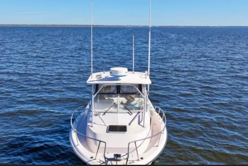 Slide: The Image of 2003 Grady-White Marlin 300 boat on open water, viewed from the front. - 2