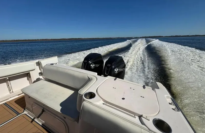 Slide: The Image of 2003 Grady-White Marlin 300 boat with twin engines cruising on open water. - 21
