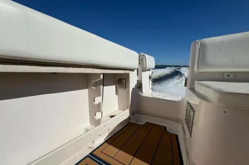 Slide: The Image of 2003 Grady-White Marlin 300 boat interior with cushioned seating and ocean view. - 22