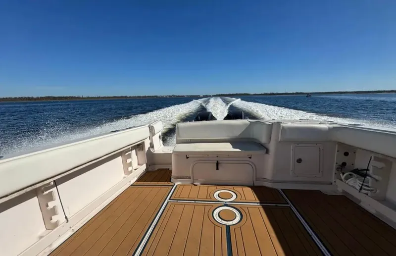 Slide: The Image of 2003 Grady-White Marlin 300 boat cruising on open water, showcasing spacious deck. - 23