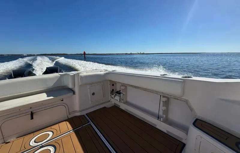Slide: The Image of 2003 Grady-White Marlin 300 boat cruising on open water under clear blue sky. - 24
