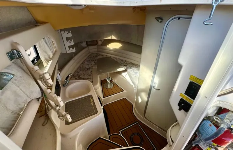 Slide: The Image of 2003 Grady-White Marlin 300 cabin interior with kitchenette and seating area. - 28