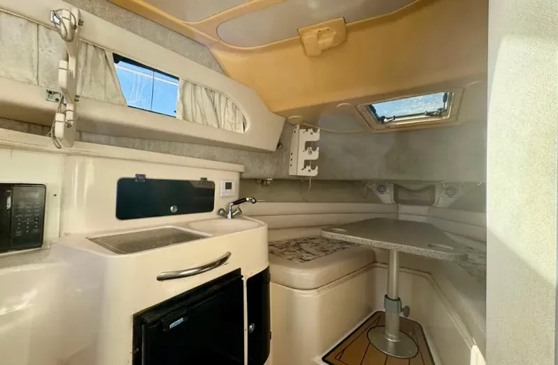Slide: The Image of 2003 Grady-White Marlin 300 cabin interior with kitchenette and seating area. - 34