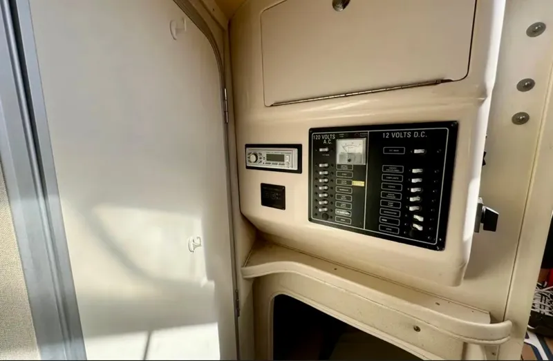 Slide: The Image of 2003 Grady-White Marlin 300 electrical panel with control switches and door. - 39