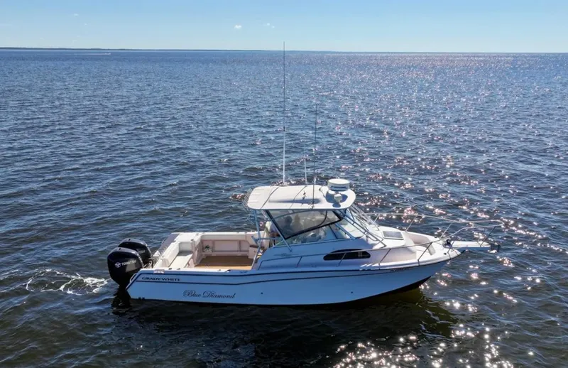 Slide: The Image of 2003 Grady-White Marlin 300 boat on open water under clear blue sky. - 4