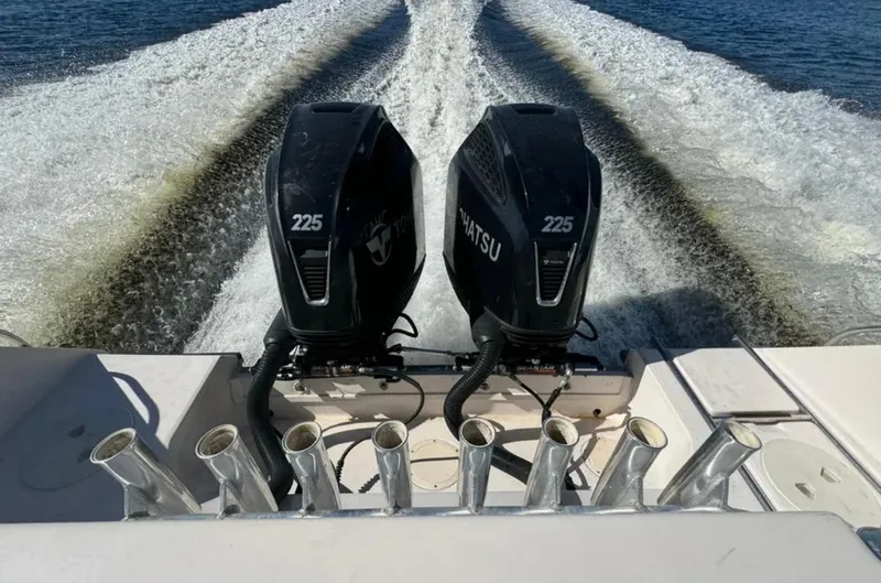 Slide: The Image of Twin Tohatsu 225 engines powering a 2003 Grady-White Marlin 300 on open water. - 9