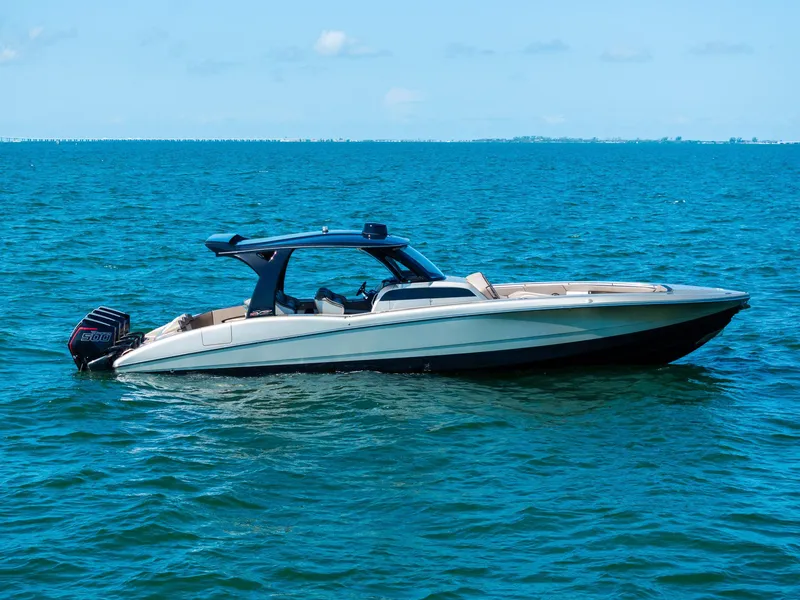 The Image of 2021 MTI V42 boat on calm blue water under clear sky. - 0